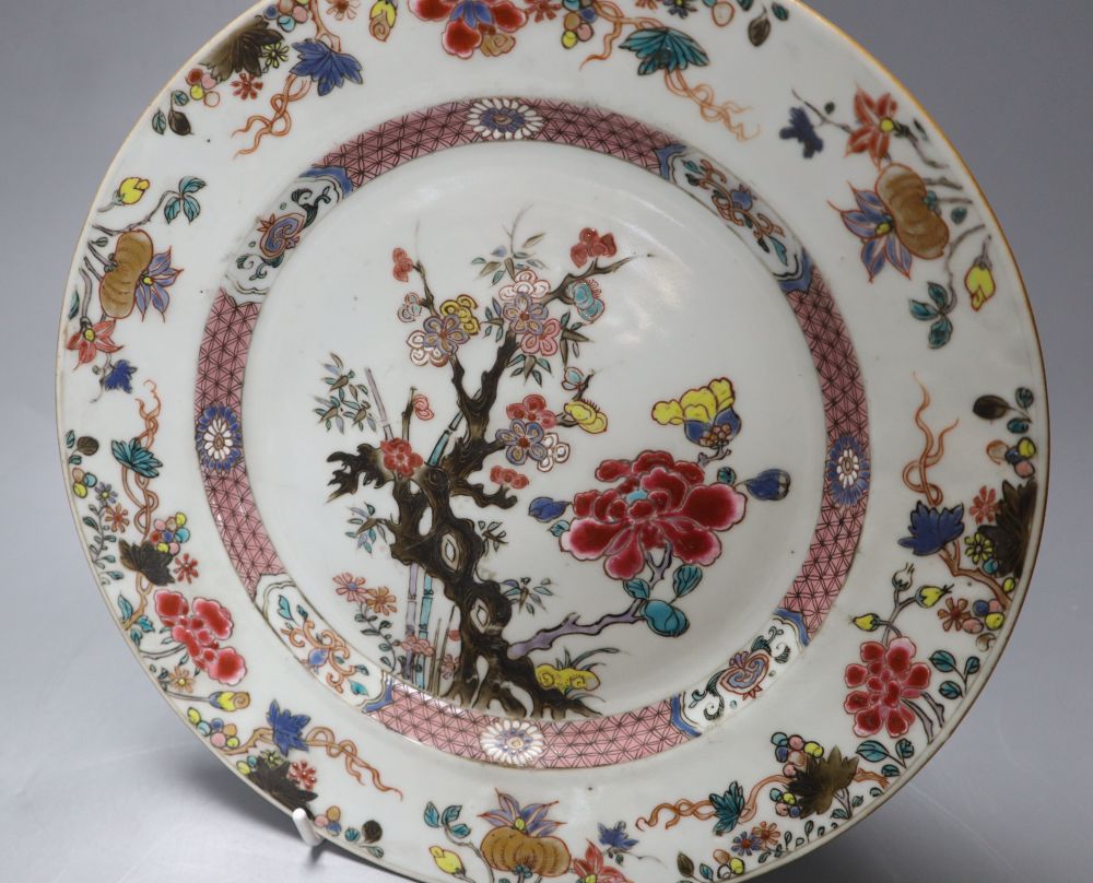 A 18th century Chinese famille rose export plate and an 18th century export teapot, cover and stand (the latter repaired)